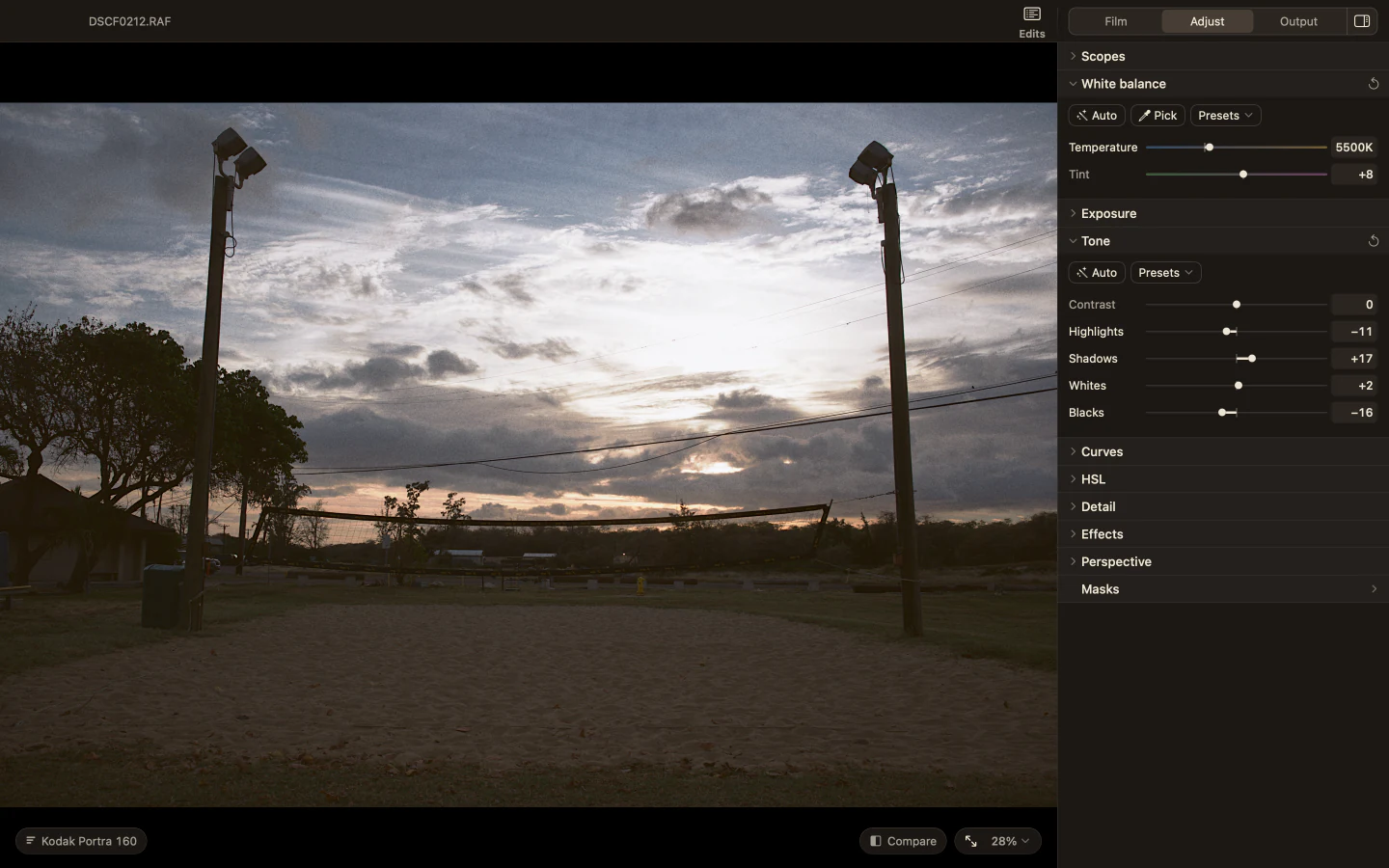 Milkglass with the White balance and Tone sections open beside a sand volleyball court at sunset.
