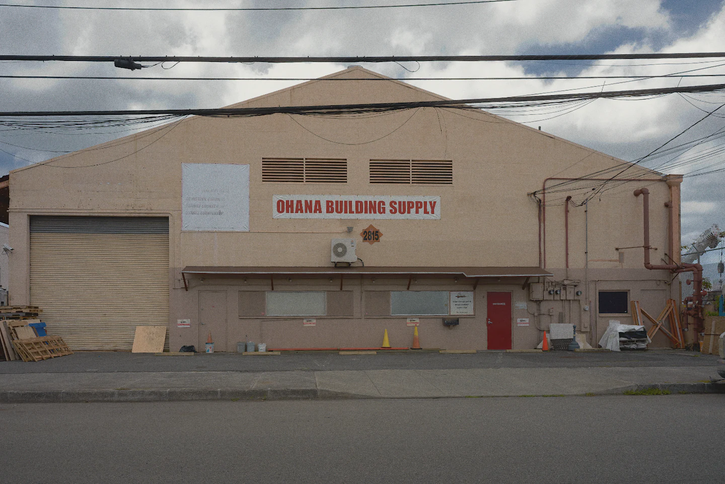 The same warehouse edited in milkglass, squared up, the sky darker, with Kodak Gold 200.